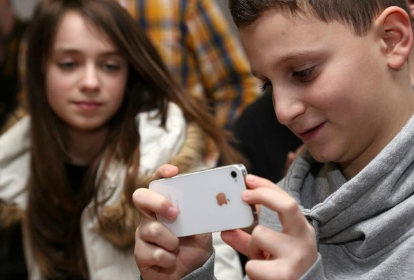 BERLIN, GERMANY - FEBRUARY 11: A student uses an Apple iPhone smartphone at the Friedensburg Oberschule (Friedensburg high school) during the tenth annual Safer Internet Day (SID) on February 11, 2014 in Berlin, Germany. Safer Internet Day (SID) is held internationally to promote safer and more responsible use of online technology and mobile phones, particularly amongst younger people. (Photo by Adam Berry/Getty Images)